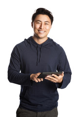 Attractive mature man wearing a blue hoodie shirt with a big smile, using his wireless digital tablet. Standing against a white background.