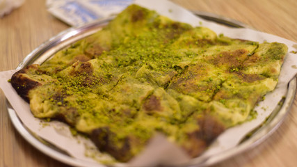 Katmer is a traditional and authentic Turkish dessert, it is made by filling between the layers of dough with pistachios and cream.