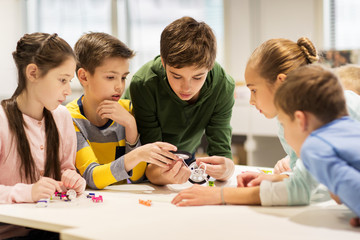 happy children building robots at robotics school
