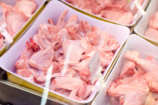 poultry meat in bowls at grocery stall