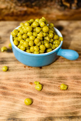 Steamed and chilled green peas ready to eat. Sweet and fresh to the taste. Here in a blue small enameled cast iron pot.