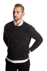 Handsome blonde mature man, standing against a white background wearing a dark sweater, white shirt...