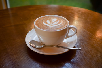 hot coffee cup on wooden table on brown background