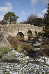 Fototapeta na wymiar The East Dart River and road bridge built in the 1700's at Postbridge on Dartmoor in Devon England UK. January 2017