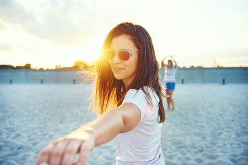 Fototapeta na wymiar Woman in sunglasses reaching hand outward