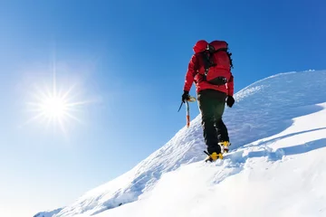Papier Peint photo Lavable Alpinisme Extreme winter sports: climber reachs the top of a snowy peak in the Alps. Concepts: determination, success, brave.
