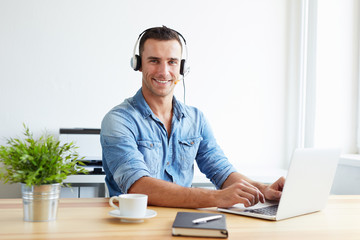 Male operator with headset in the office. Assistant in a call center