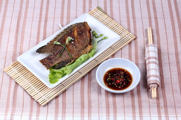 Deep fried little tilapia fish served with spicy bean sauce.