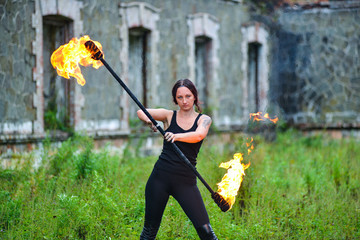 Fire show girl with flaming torches