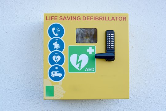 Automated external defibrillator mounted on a outside wall
