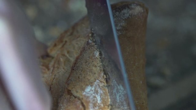 Close up of female hands slicing white bread, super slow motion 240fps
