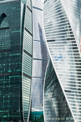 Fototapeta na wymiar modern skyscrapers of iron and glass reflecting background close up