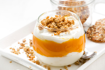 dessert with pumpkin, cream and biscuits, closeup