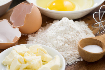 fresh ingredients for baking on a wooden board, selective focus
