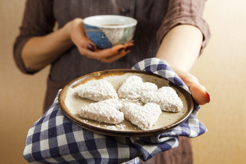 Hands holding valentine biscuit and coffee. Valentine's Day Concept