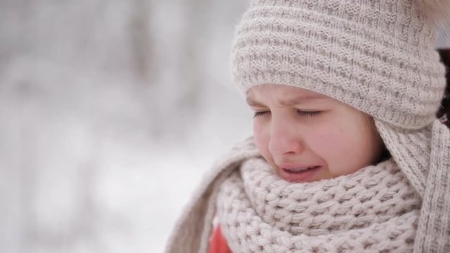 blind girl crying in the winter forest. The girl lost her sight.