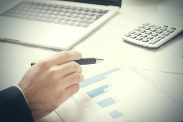 Report. Business man in office with charts