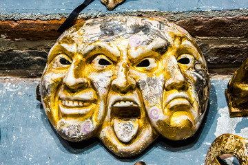 Venice mask of triple face happy, angry and sad. Original unique golden color Venice mask of three...
