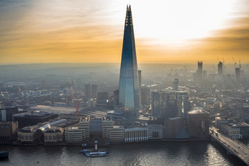 One of the tallest buildings in London - The Shard tower rising above the river Thames and...