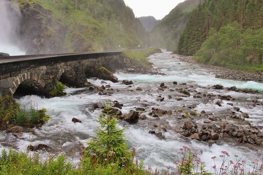 Old Bridge and White water stream at the end of the twin waterfall Latefossen in Norway, not far from the town Odda. Western norway, scandinavia, Europe