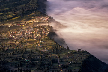 Touch of morning light on fog and mist at Cemoro Lawang village