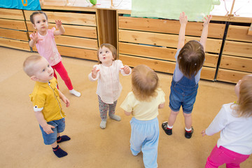 Children playing with soap bubbles in kindergarten