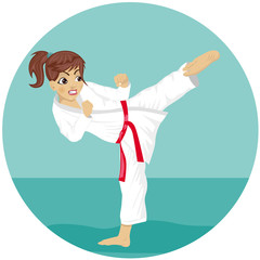 Young teenager red belt karate girl in kimono practicing kick exercise