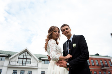 gorgeous happy wedding couple walking and kissing in the old city of Minsk, Belarus
