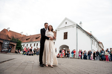 gorgeous happy wedding couple walking and kissing in the old city of Minsk, Belarus