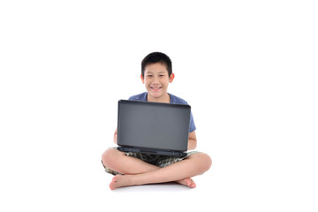 Asian boy with laptop sitting on white background
