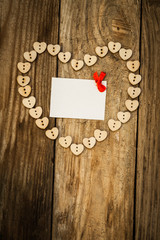 On the White Isolated Letter and Нeart from buttons on a wooden background. Valentine`s day.