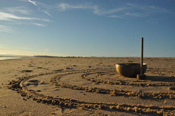 Singing bowl on the beach with circles