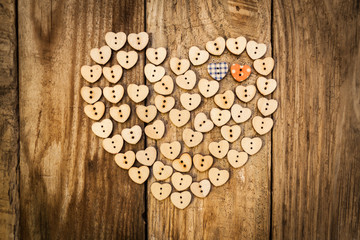 Valentine`s day. Нeart from buttons on a wooden background