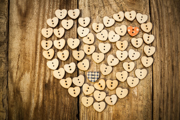Fototapeta na wymiar Valentine`s day. Нeart from buttons on a wooden background