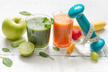 Fruits, vegetables, juice, smoothie and dumbell health diet and fitness lifestyle concept
