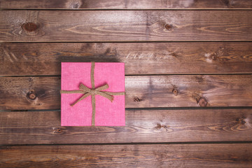 Wrapped vintage pink gift box on wooden background can use on valentine day mother day or celebrate love day .