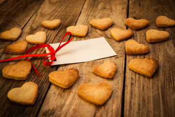 On the White Isolated Letter and Gingerbread Cookies in the Shape of Heart at Valentine Day. On the wooden background