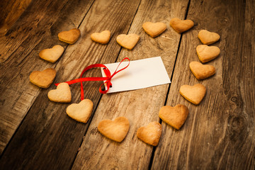 On the White Isolated Letter and Gingerbread Cookies in the Shape of Heart at Valentine Day. On the wooden background