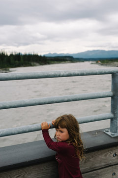 Sad girl standing on the bridge
