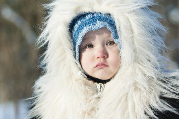 Little girl in a fur coat from natural fox fur - 133803858