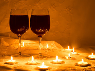 Candles and two glasses of red wine