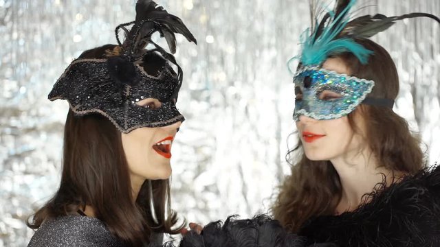 Happy women chatting with each other at the masquerade party, steadycam shot
