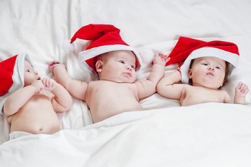 Three cute newborn Santa