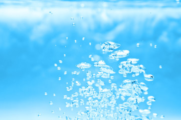 Naklejka na ściany i meble closeup of blue bubbles underwater
