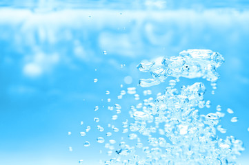Naklejka na ściany i meble closeup of blue bubbles underwater