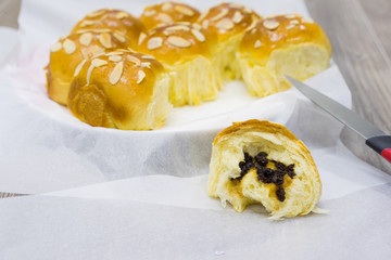 Homemade sweet bun with almond and dried grape