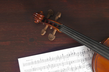 Music notes and violin on table