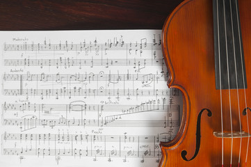 Fototapeta na wymiar Music notes and violin on table
