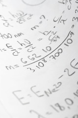 sheet of paper filled with calculations of nuclear and quantum p