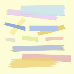 Colorful masking, sticky tape pieces on light beige background